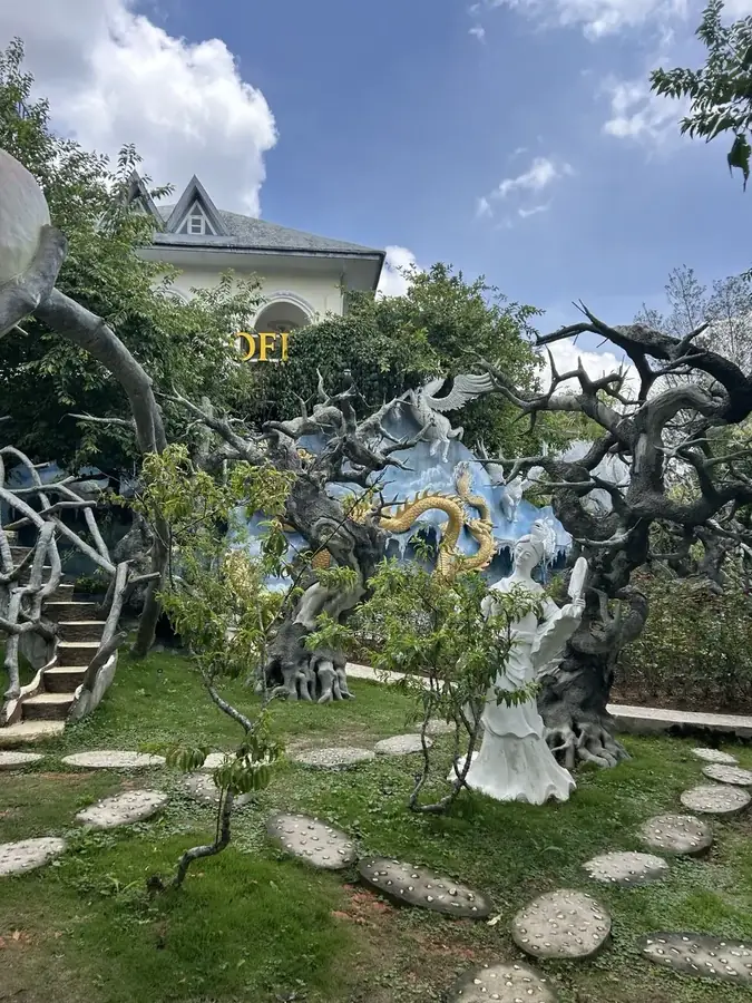 The Crazy House yard: concrete branches and a path of stone slabs, Da Lat