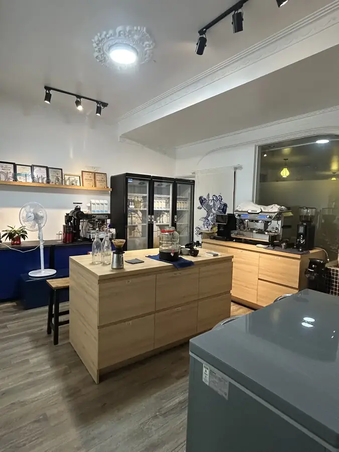 The training room: a long bar and a wall of certificates — dhc Coffee Lab — latte art and a barista school, Da Lat