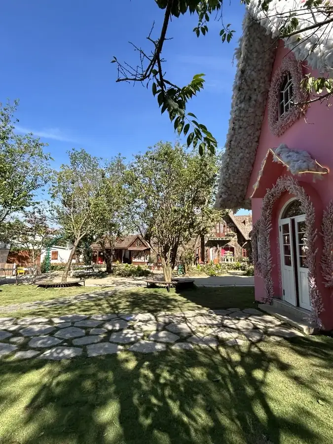 The pink thatched cottage on the lawn, Puppy Farm — Puppy Farm, Da Lat