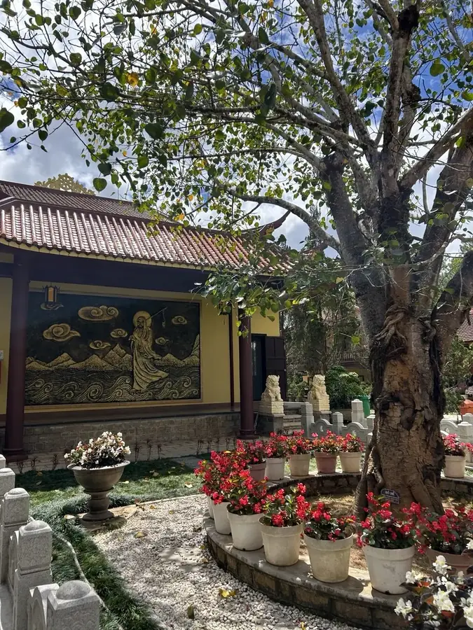The courtyard with flowers and a wall relief, Truc Lam monastery, Da Lat