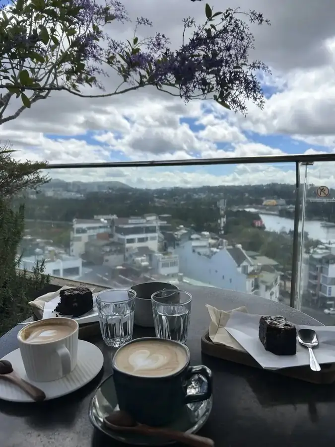 Cappuccino and cakes on the terrace edge above central Da Lat